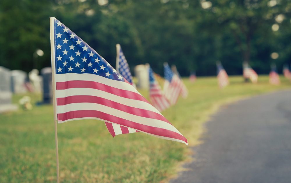 American flags displayed at a cemetery on Memorial Day. Vintage tone.
