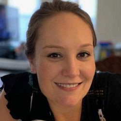 Elisabeth Anderson smiling at the camera in an office background.